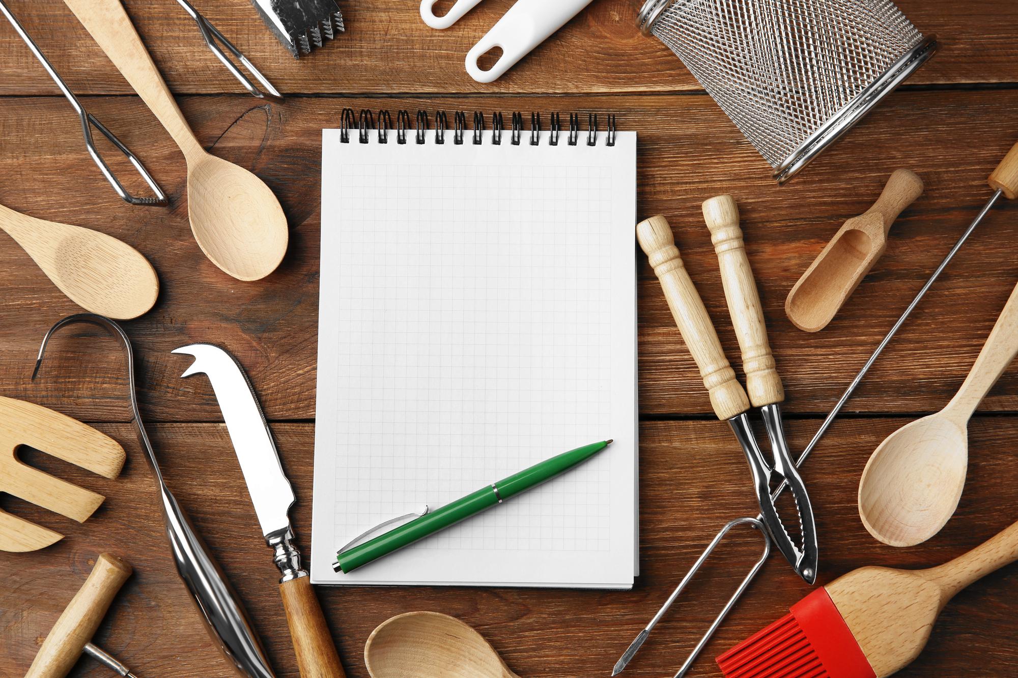 Flat lay of planning notes and kitchen tools